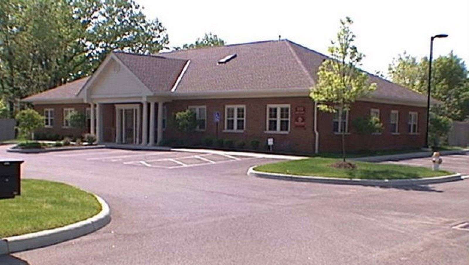 Brick commercial building at 101 Commerce Park Drive with curved driveway and manicured landscaping.