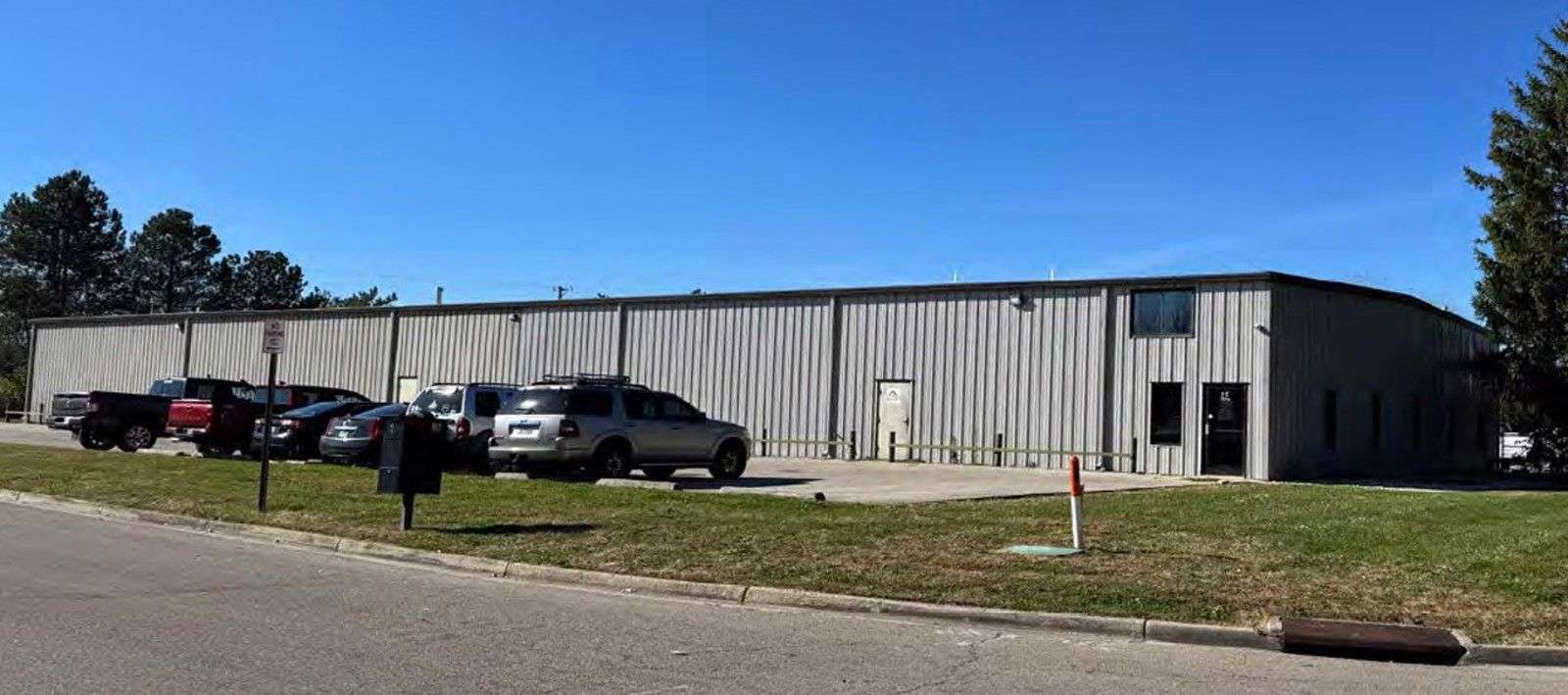 Industrial warehouse building with parked vehicles at 15 Industry Park Court, Tipp City, Ohio.