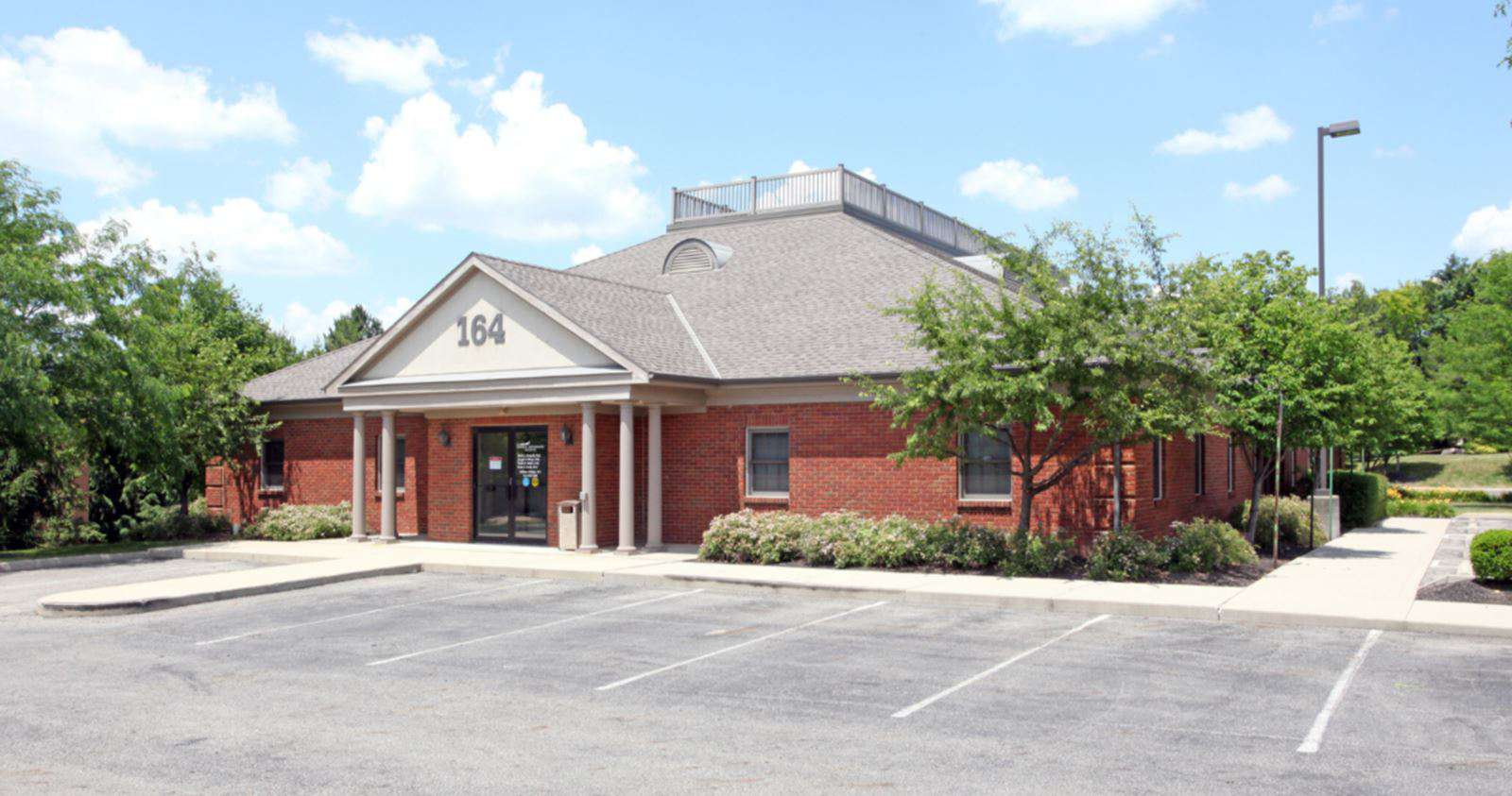 Red brick commercial building with columns at 164 Wetherby Lane, Westerville, Ohio.