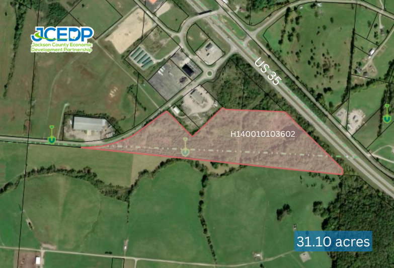 Aerial map showing a 31.10-acre parcel highlighted in pink near a highway with surrounding agricultural land.