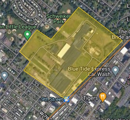 Aerial map view of Schweiker Park area with highlighted yellow zone showing fields and surrounding businesses including Blue Tide Express Car Wash.