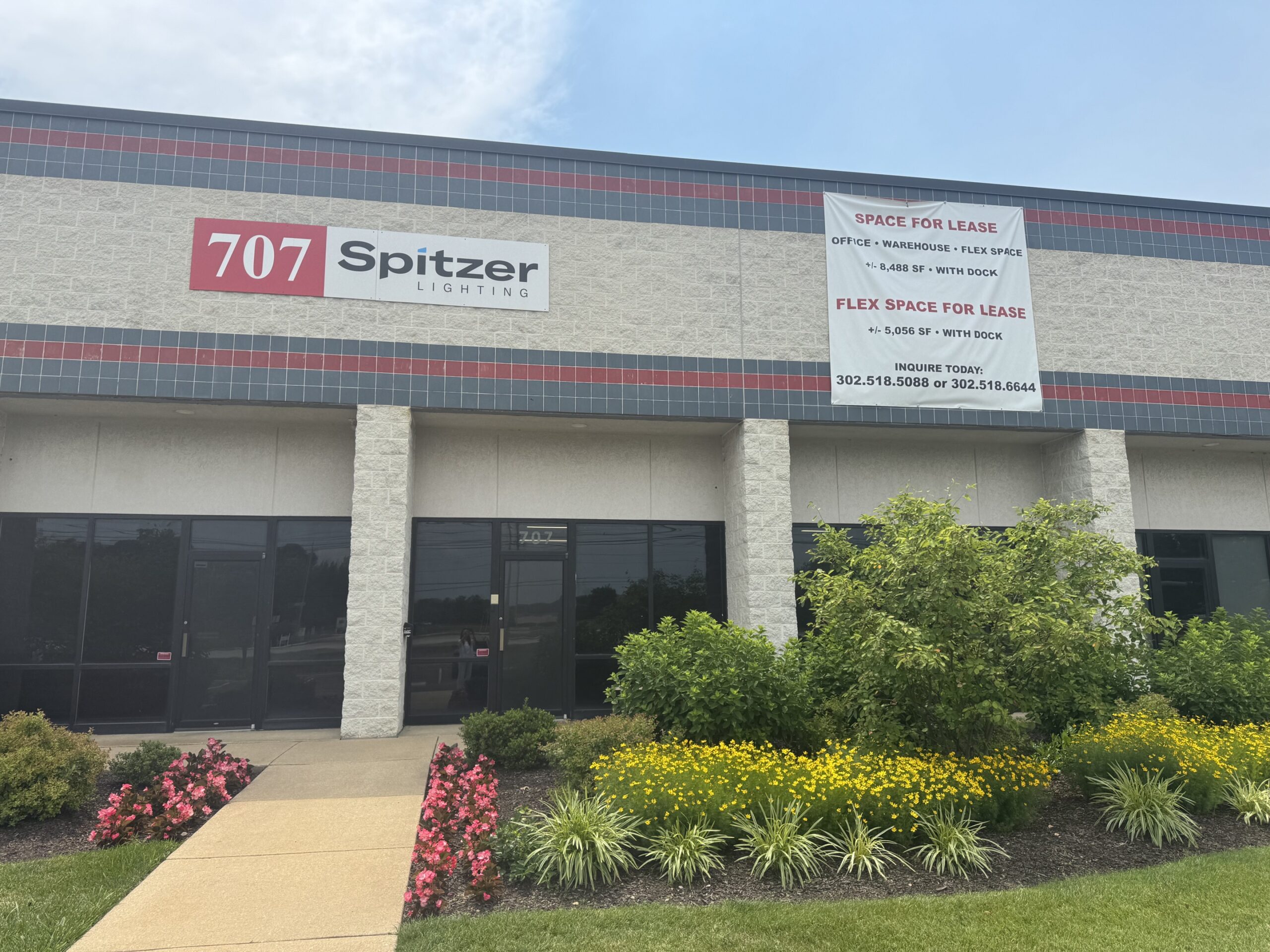707 Spitzer commercial building with "Space for Lease" signage and landscaped front entrance.