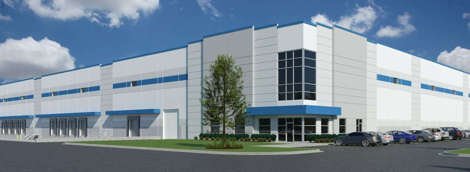 North Dayton Distribution Center Phase II, a modern white industrial warehouse with blue accents and parking lot.