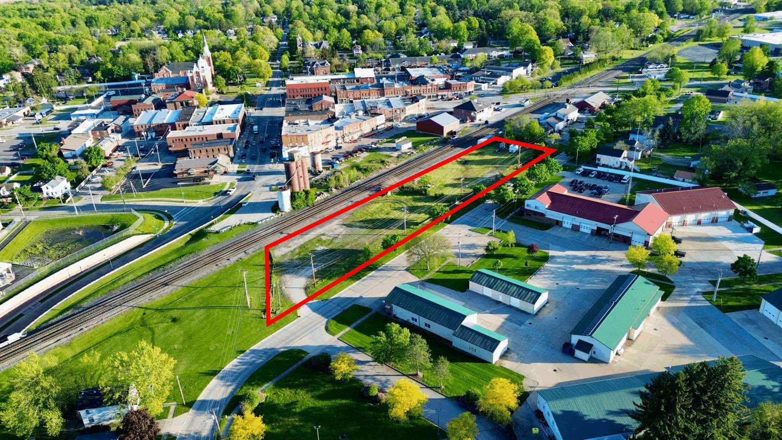 Aerial view of 217 Kelly Street residential property with red outline showing land boundaries, surrounded by green spaces and neighboring homes.