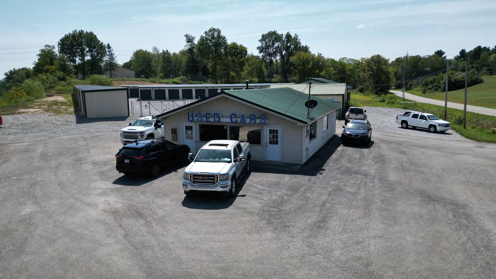 Aerial view of a single-story commercial building with green roof at 3540 Eden Road surrounded by parking lot and trees.