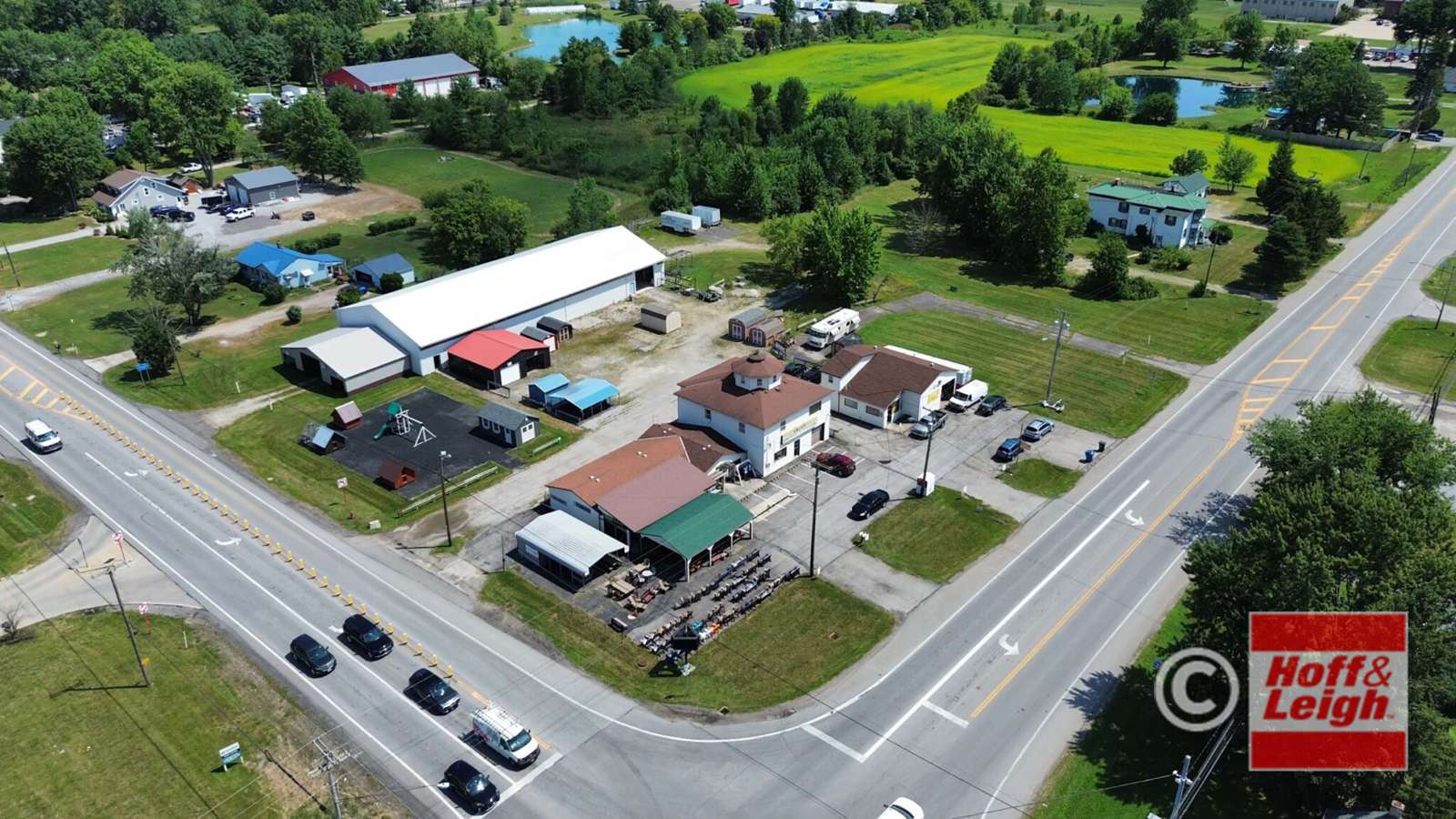 Aerial view of commercial property at 35980 Royalton Road with multiple buildings and vehicles parked along a highway.
