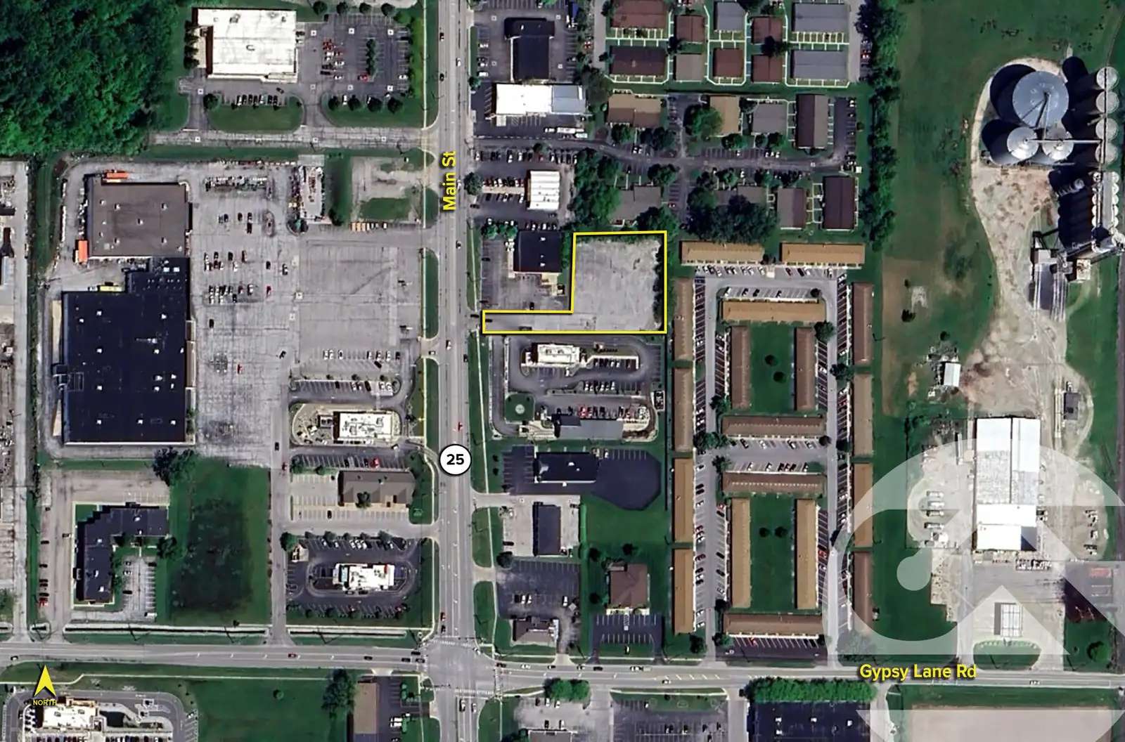 Aerial view of downtown area showing Main Street with surrounding buildings, parking lots, and green spaces.