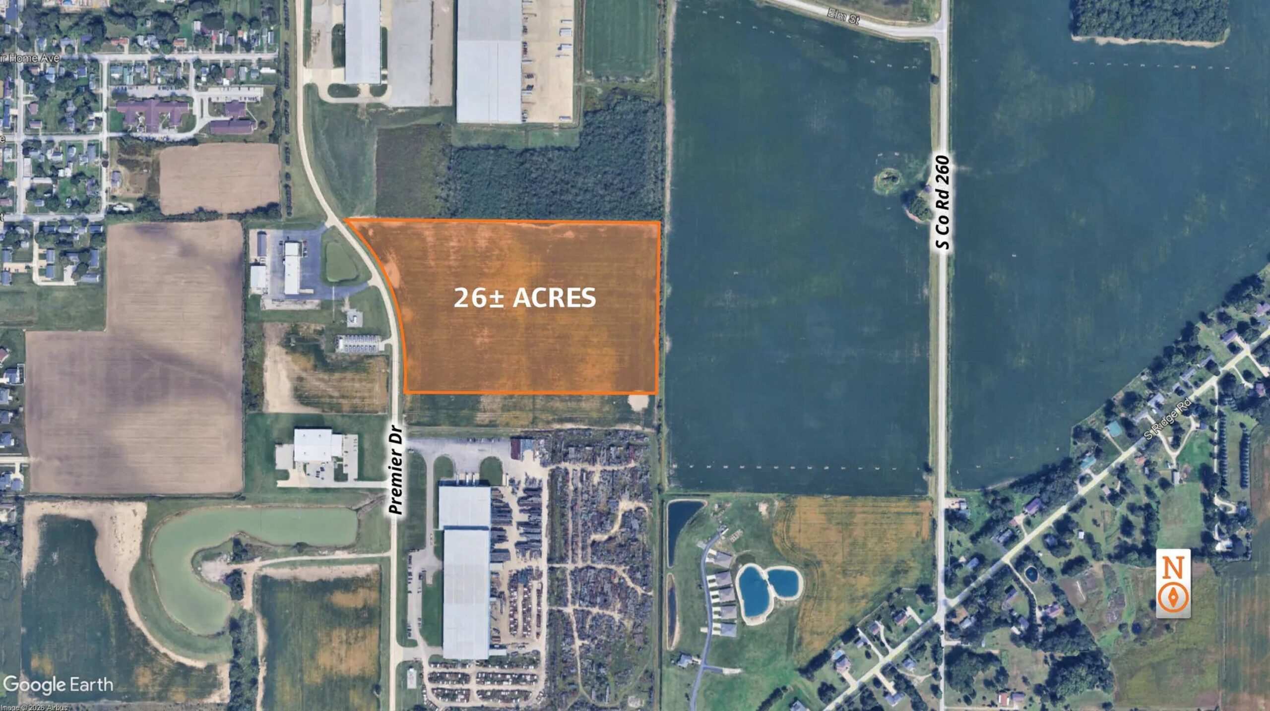 Aerial view of a 262-acre parcel of undeveloped land highlighted in orange with surrounding residential and commercial development.